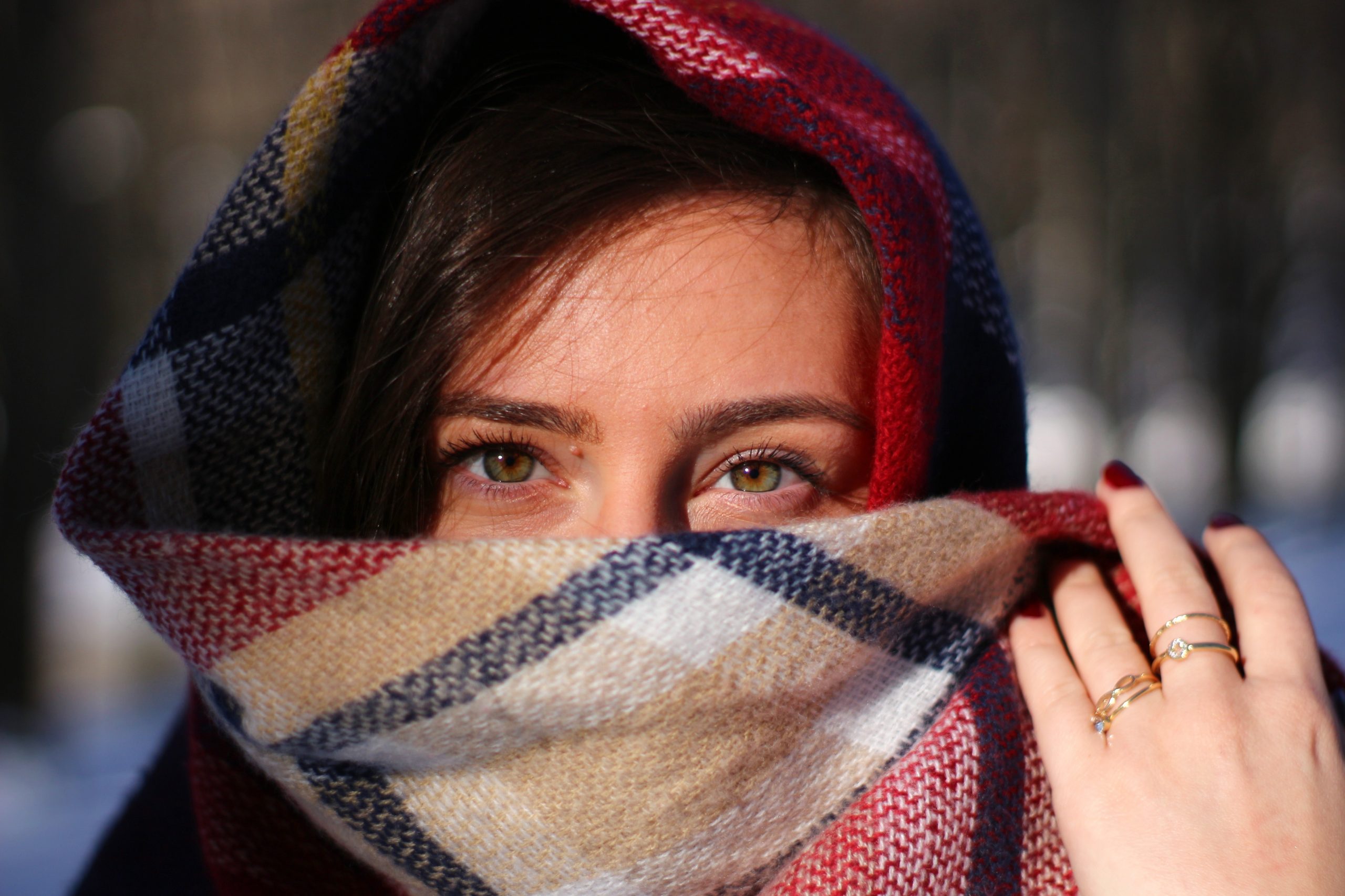 woman-covering-her-face-with-scarf-4376410